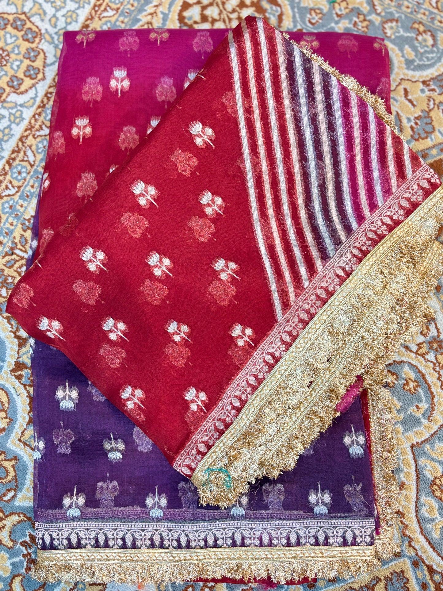 Maroon and purple handloom saree with white motifs, striped panel, and gold border
