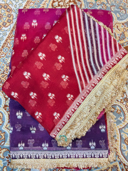 Maroon and purple handloom saree with white motifs, striped panel, and gold border