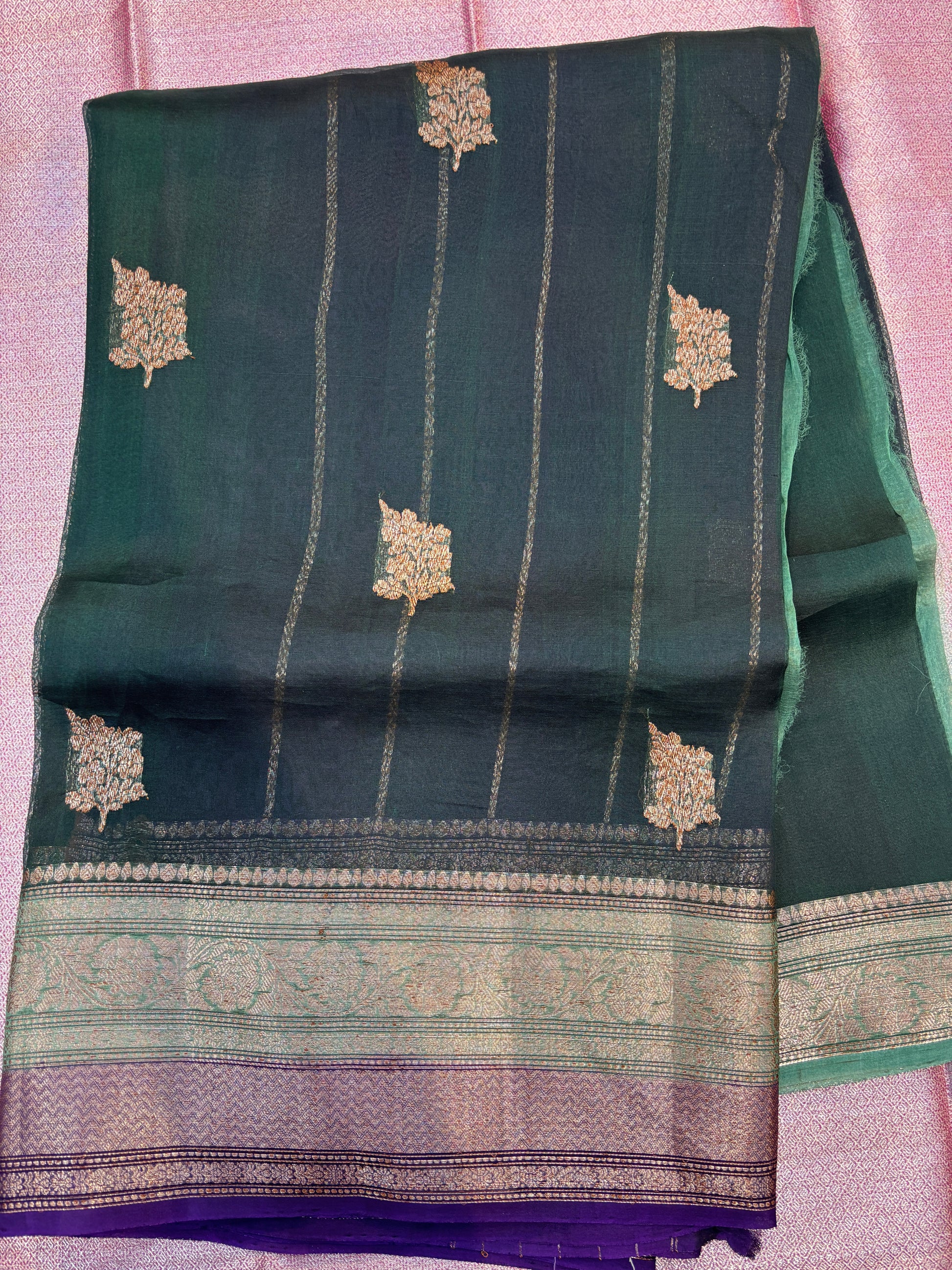 Teal handloom saree with scattered gold motifs and silver-purple border band