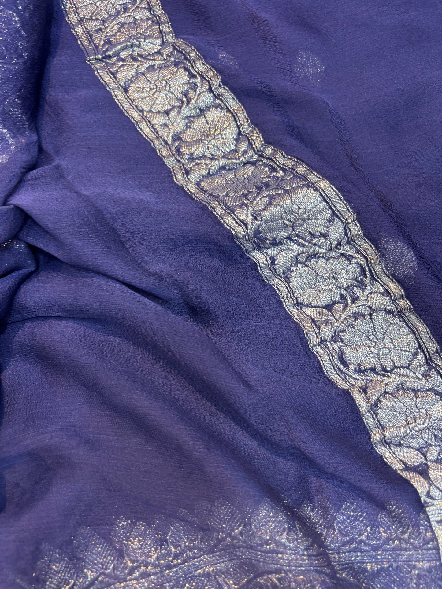 Purple chiffon saree with silver zari border and detailed woven pattern strip