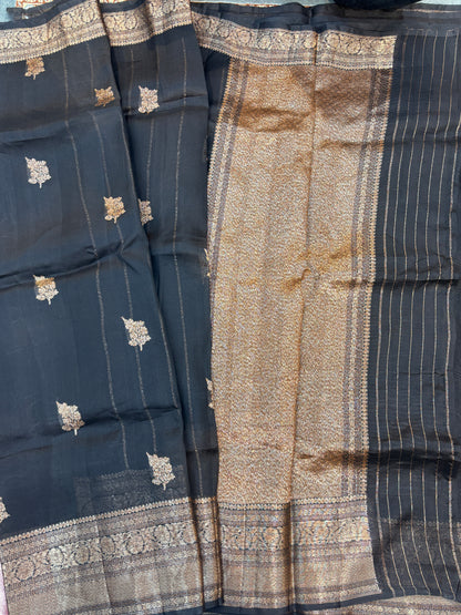 Dark silk saree with gold floral motifs and vertical striped pallu section