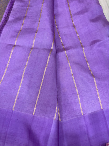 Lavender silk saree close-up with vertical gold zari stripes and light crosshatch texture
