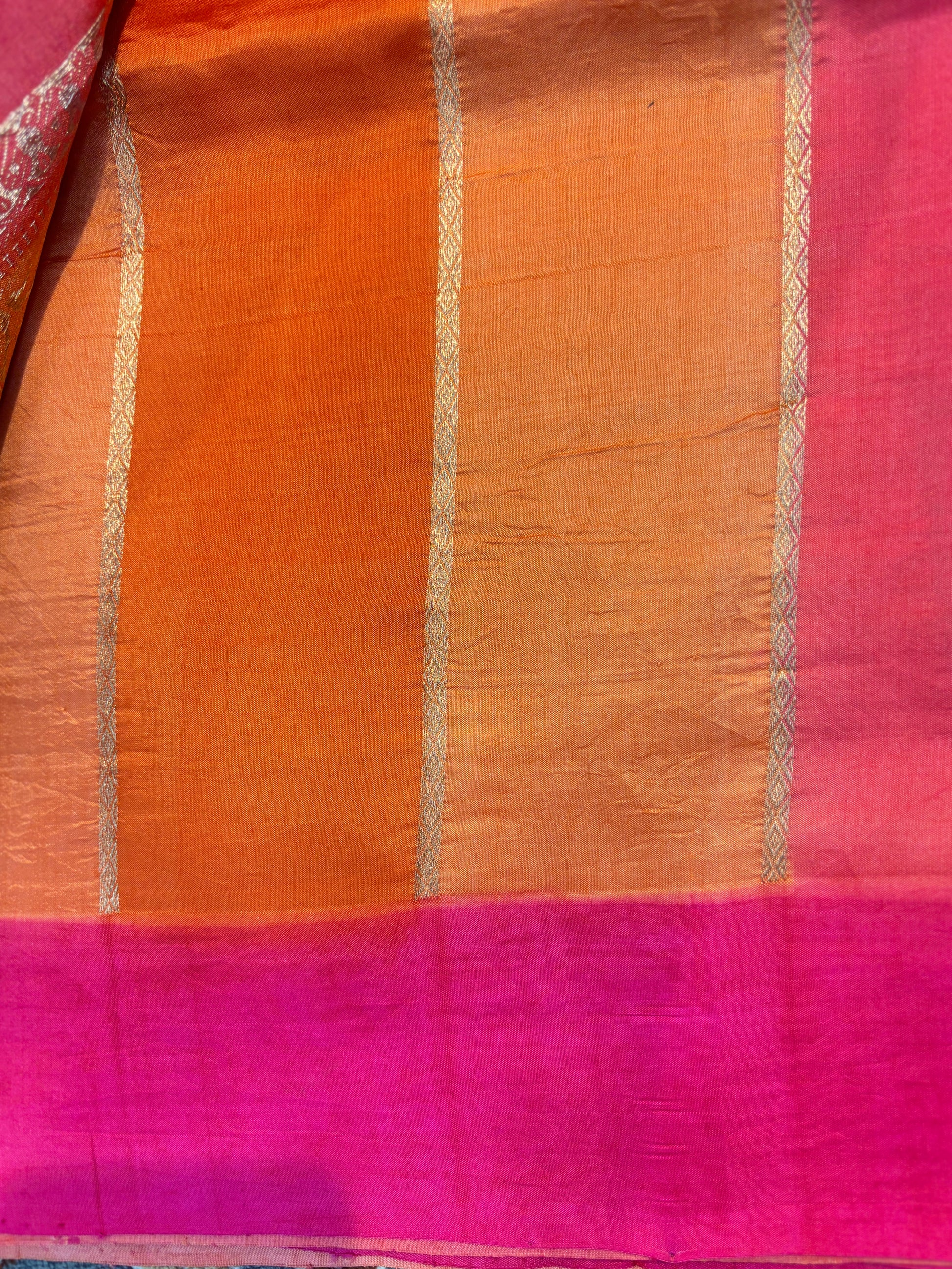 Orange-pink saree with silver vertical stripes and magenta border