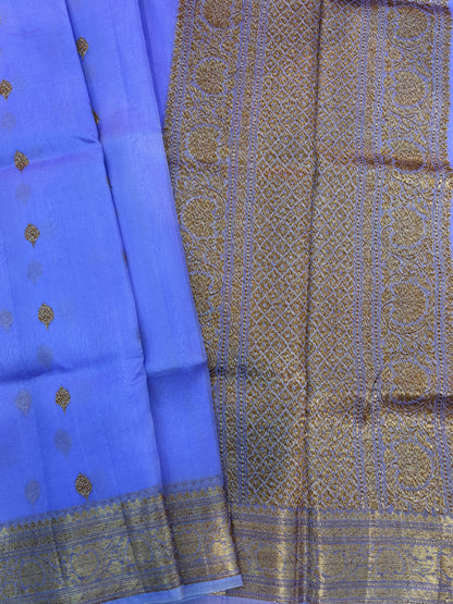 Lavender silk saree drape with woven gold zari pattern and wide border