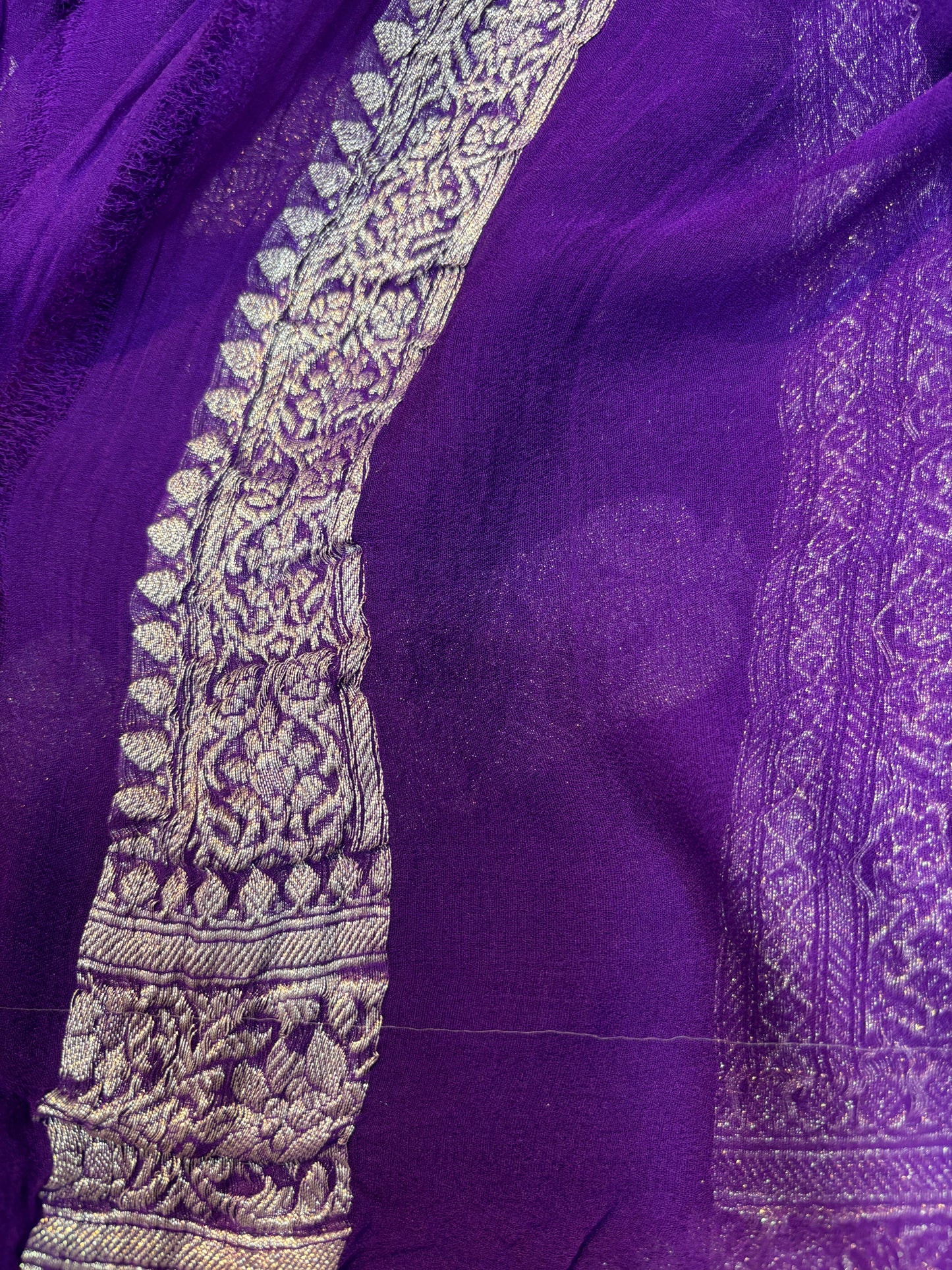 Violet chiffon saree with silver zari border and intricate woven edge