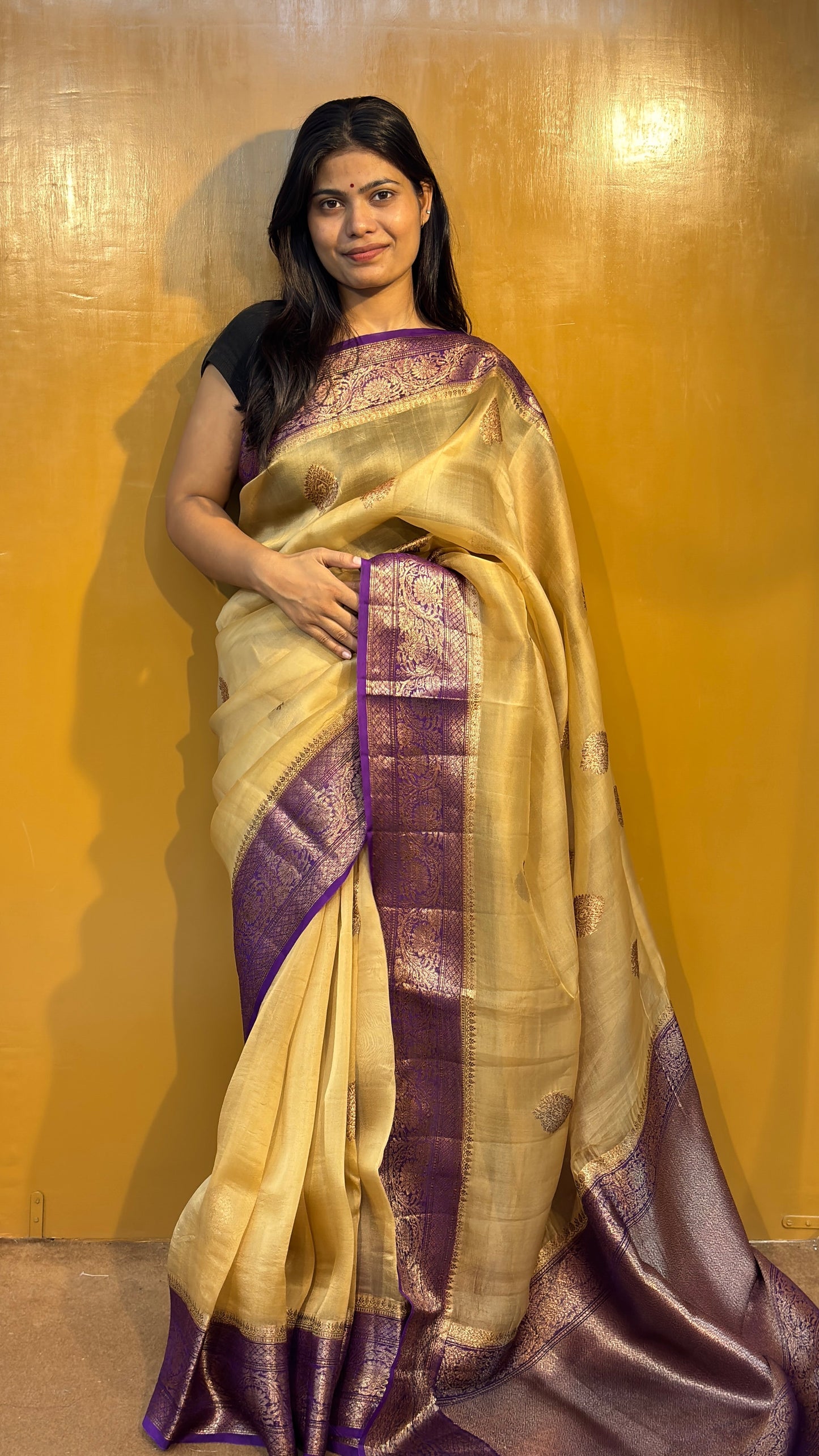 Cream saree with purple zari border and patterned gold motifs