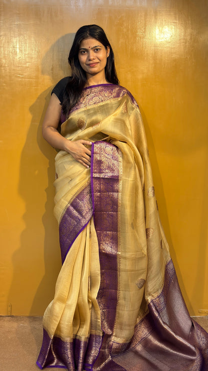 Cream saree with purple zari border and patterned gold motifs