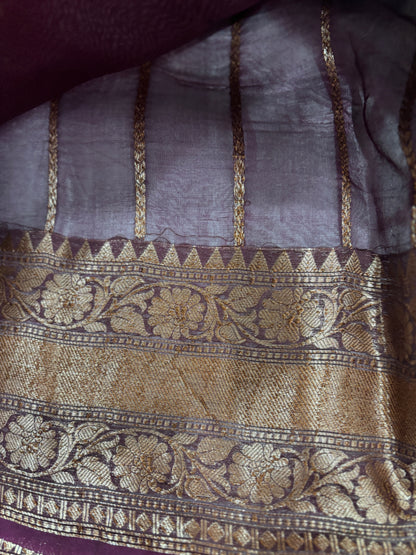 Purple silk saree with wide gold zari border and ornate floral motifs