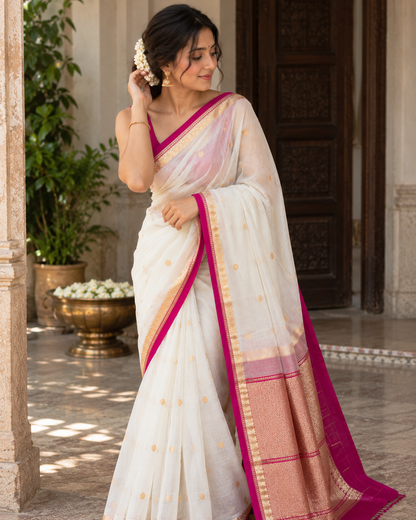 White silk saree with pink border and gold woven trim