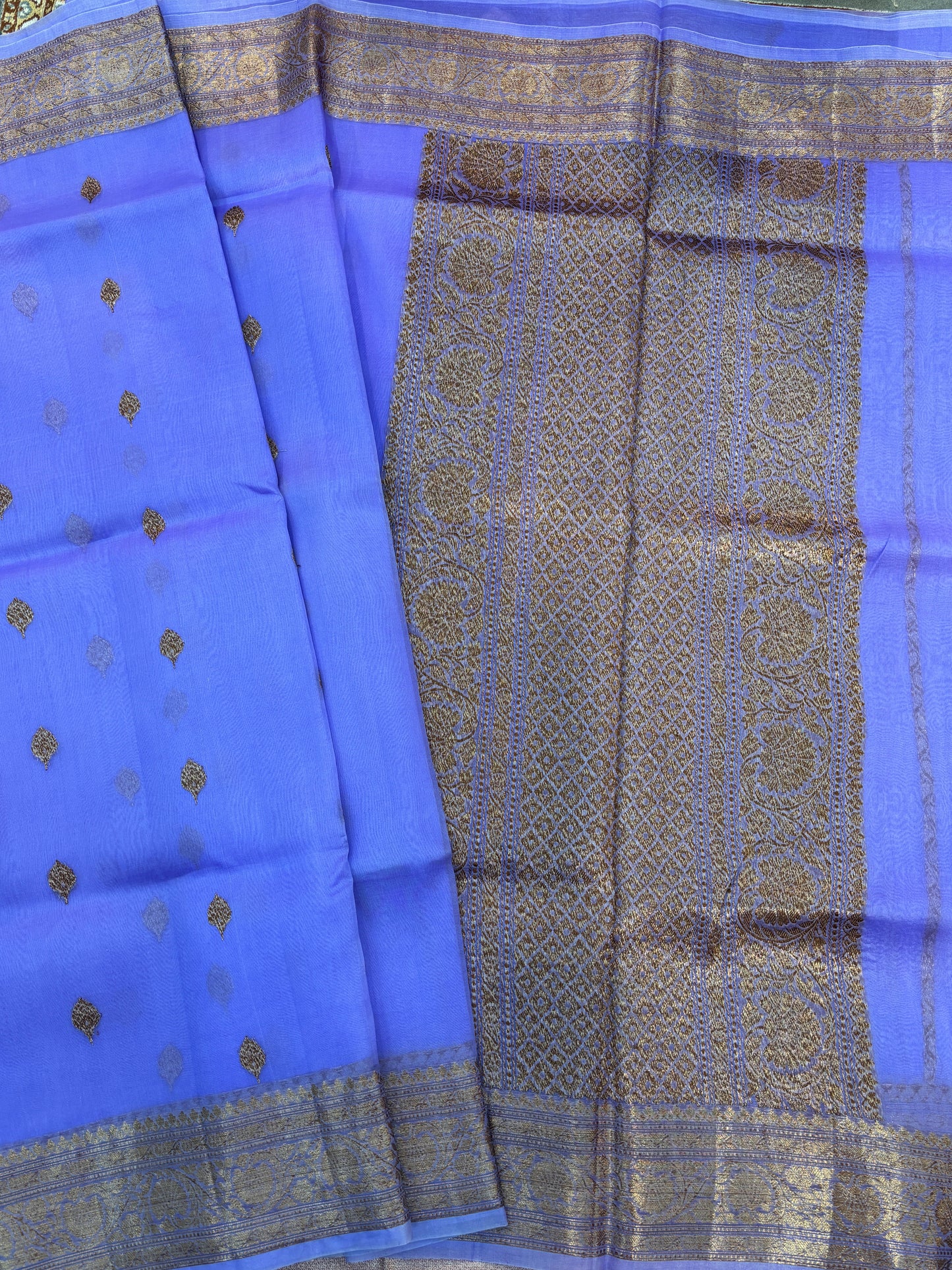Lavender silk saree with gold zari detailing and patterned panel border
