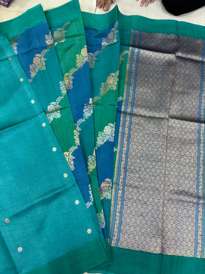 Teal silk saree with silver-gold floral vine motifs and contrasting woven border