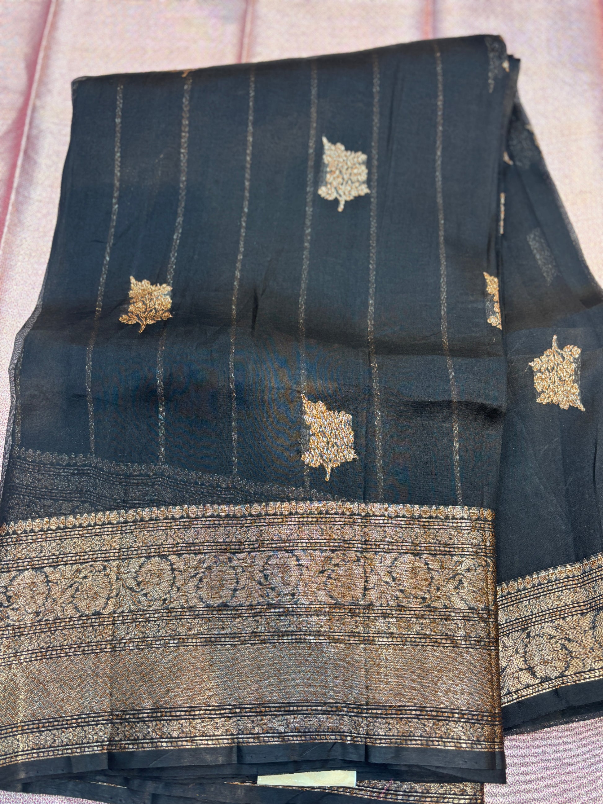 Dark silk saree with gold striped pattern and wide antique zari border