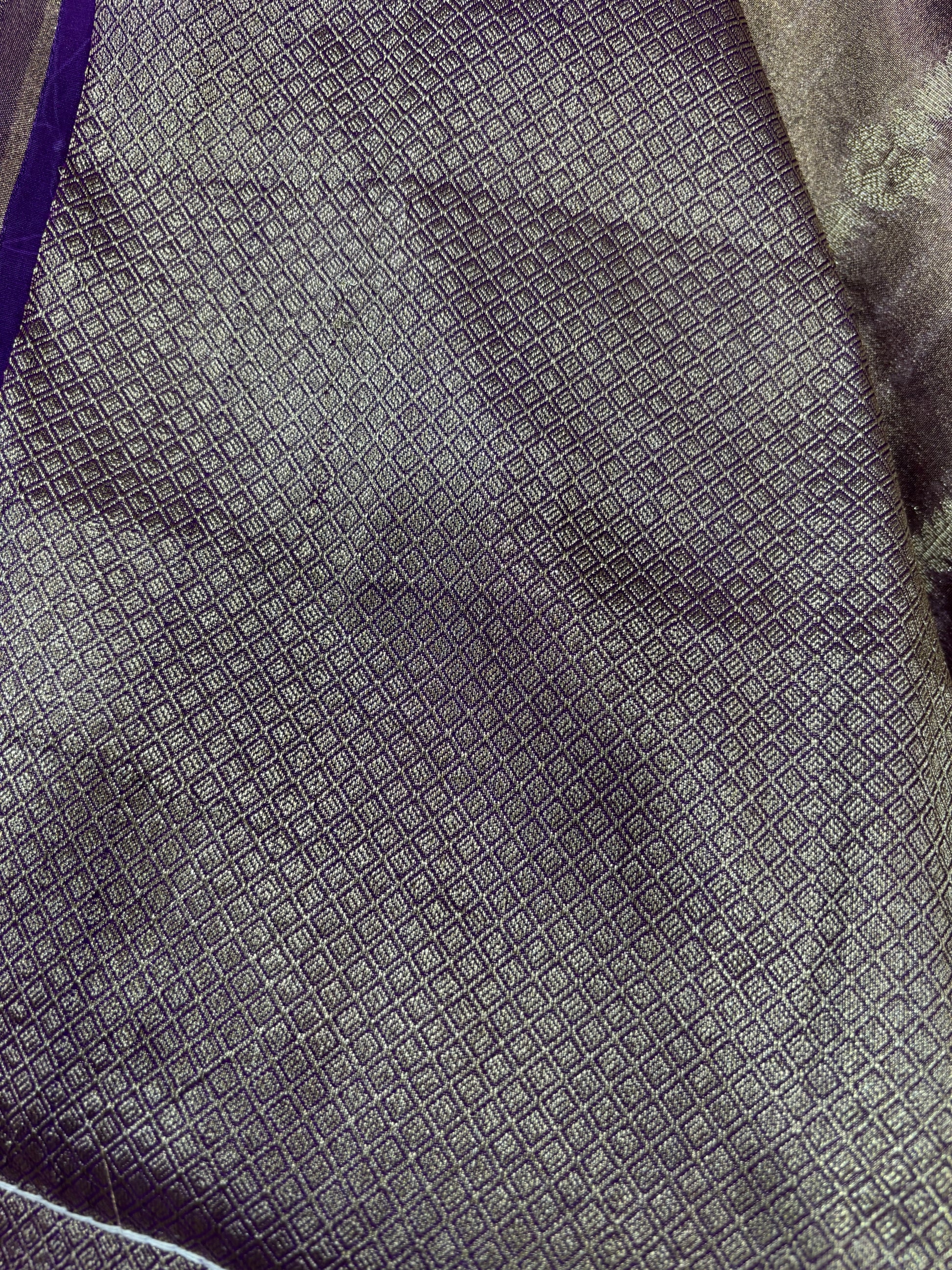 Deep purple tissue saree with small geometric texture and metallic lace edge