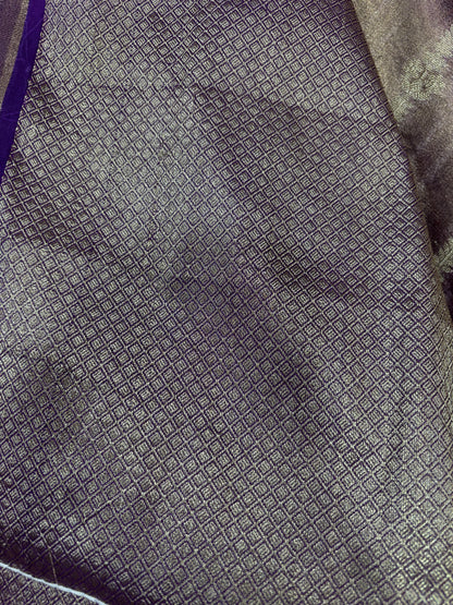 Deep purple tissue saree with small geometric texture and metallic lace edge