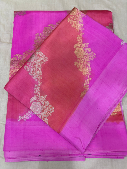 Magenta and maroon handloom saree with gold floral motifs and zari border, folded