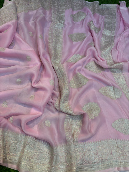 Light pink Banarasi handloom saree with gold-tone motifs and silver-tone border stripe.