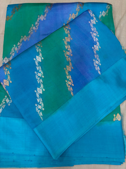 Silk saree in teal and blue with gold and green diagonal motifs