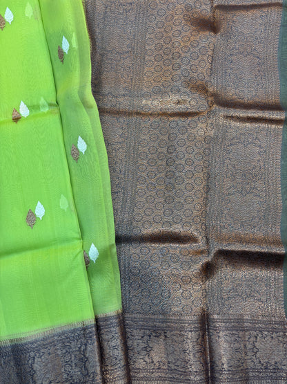 Green silk saree with small gold motifs and charcoal patterned pallu