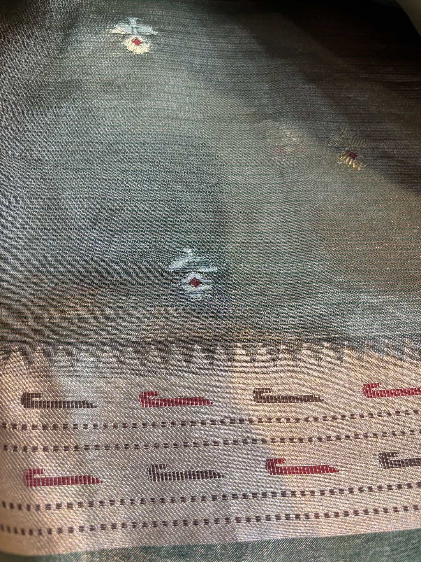 Light grey saree with scattered small motifs and dotted border with red accents