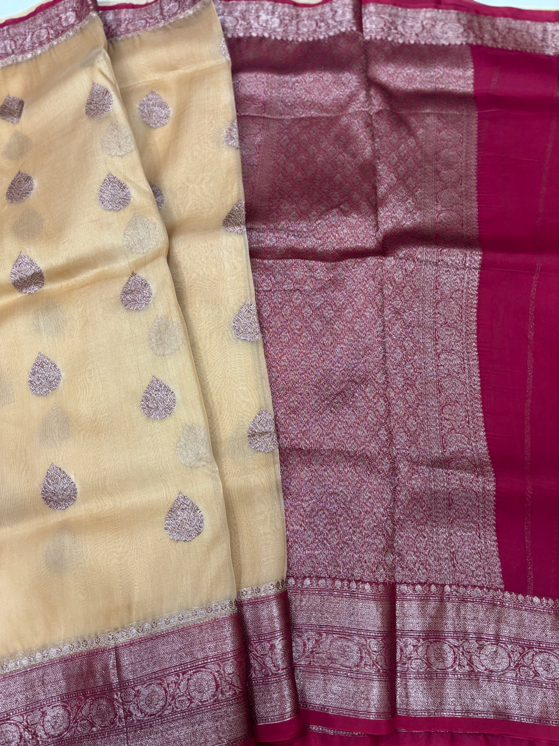 Beige silk saree with purple teardrop motifs and maroon zari border