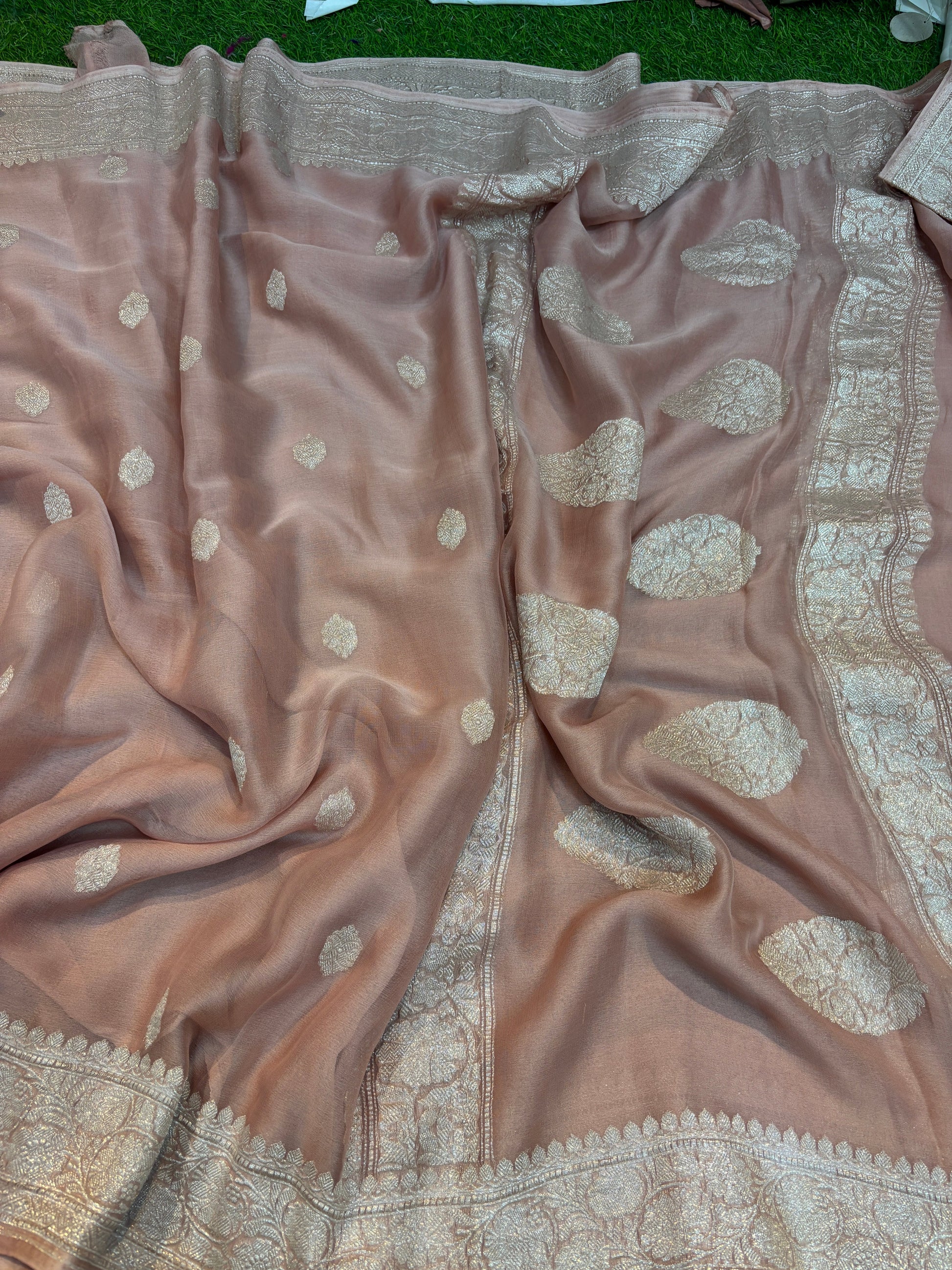 Peach pink chiffon saree with gold-toned Banarasi border and scattered leaf motifs