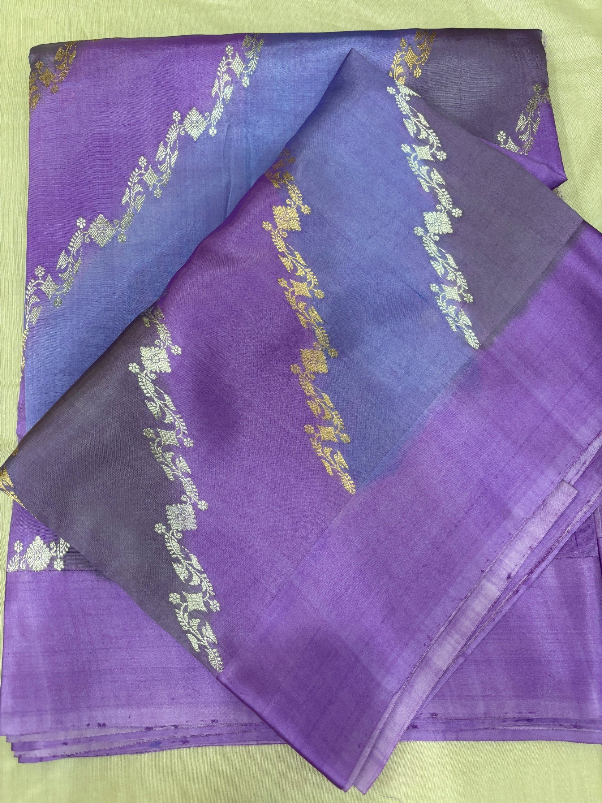 Handloom silk saree folded, purple-lavender with dark blue pallu and gold motif bands