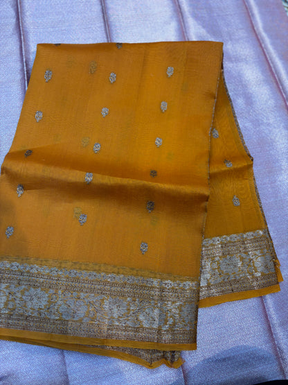 Mustard yellow saree with silver dot motifs and silver zari border on folded pallu