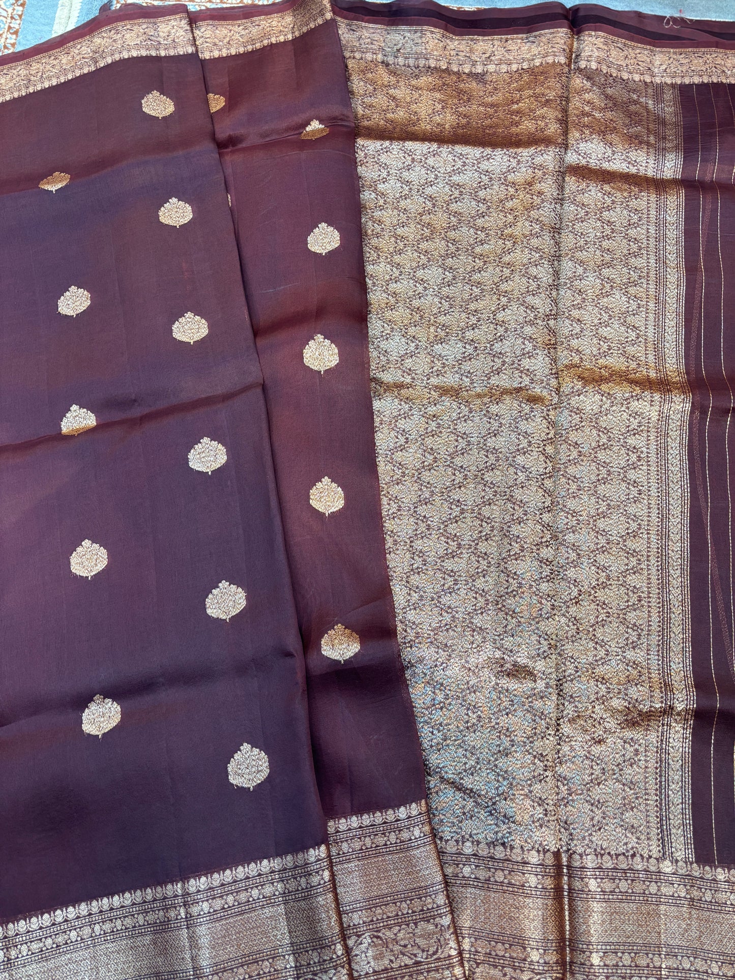 Plum silk saree drape with gold dot motifs and woven zari border stripe