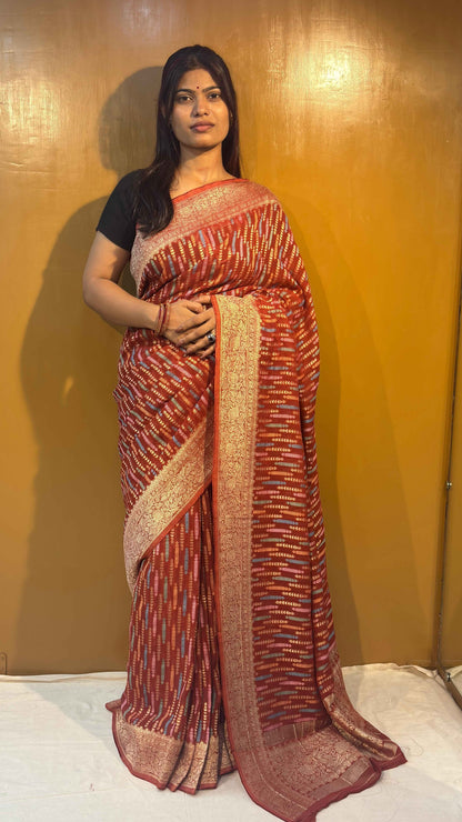 Pink saree with gold-toned stripes and wide cream-gold border, pallu on side