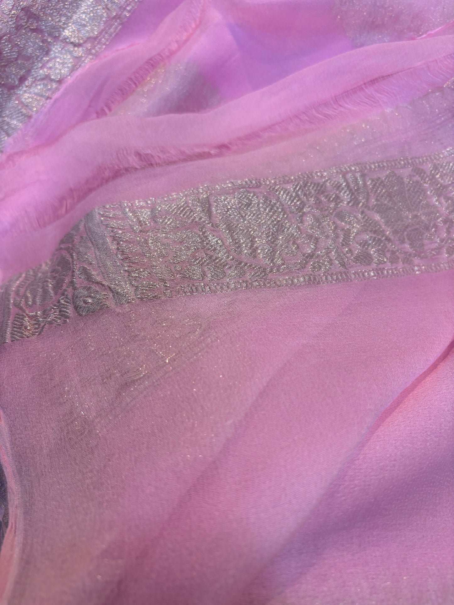 Light pink Banarasi handloom saree with silver-tone woven pattern across the border.