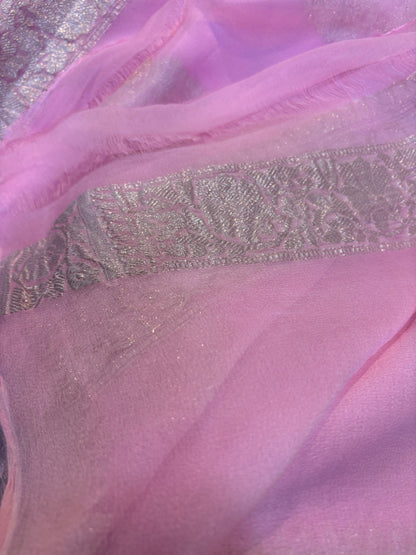 Light pink Banarasi handloom saree with silver-tone woven pattern across the border.