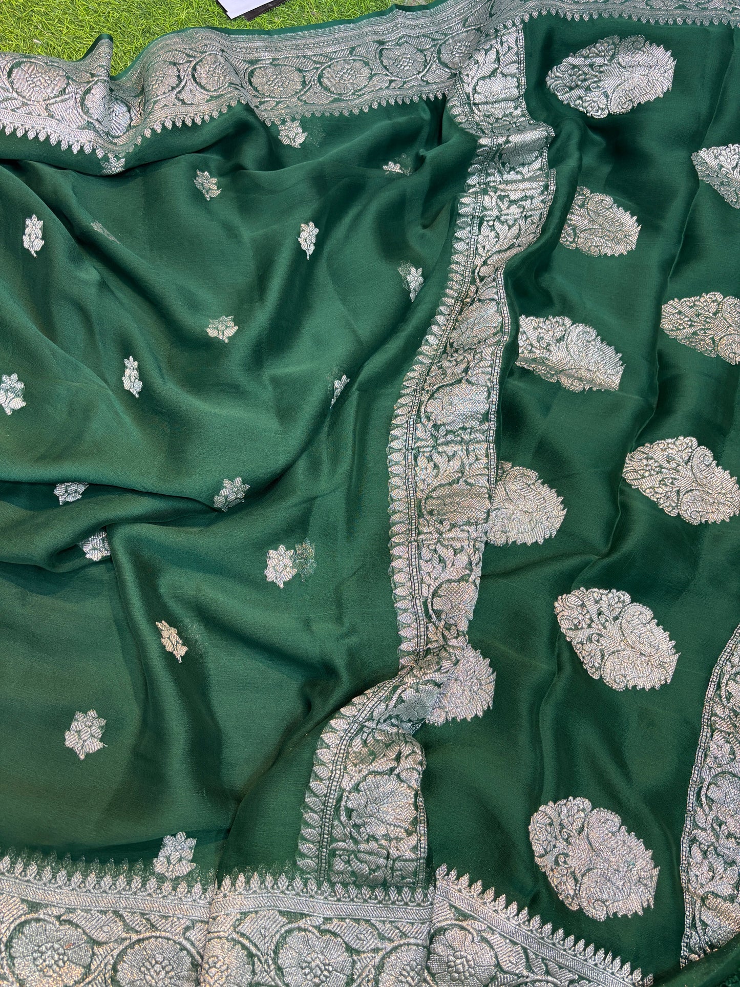 Green teal chiffon saree with silver boota motifs and wide zari-style border