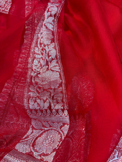 Red chiffon saree with silver zari vertical border and textured embroidered design