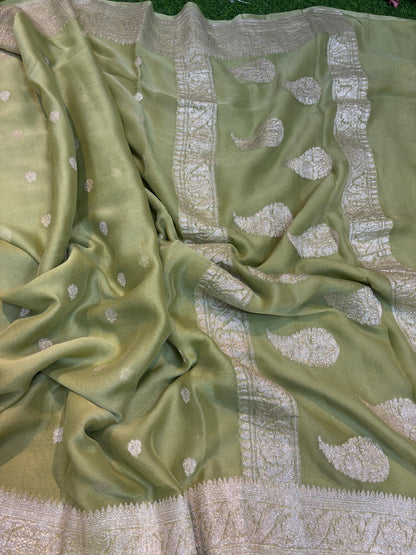 Pale green Banarasi handloom saree with silver-tone leaf motifs and patterned border.