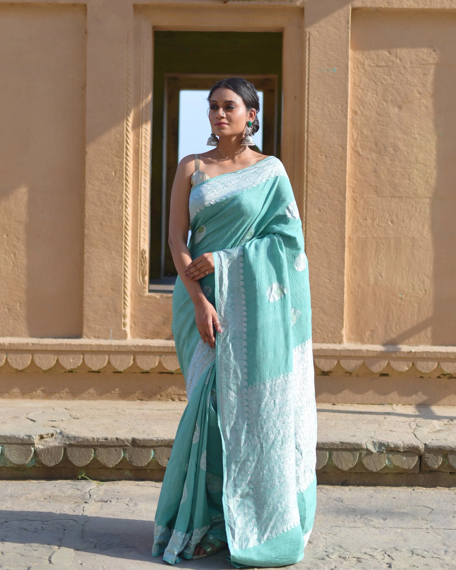 Aqua tussar georgette saree with light blue border and woven motifs