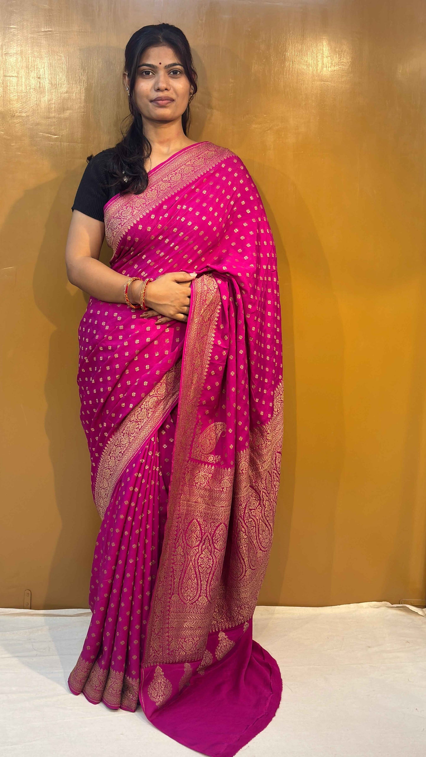 Rani pink georgette saree with gold zari border and allover small motifs