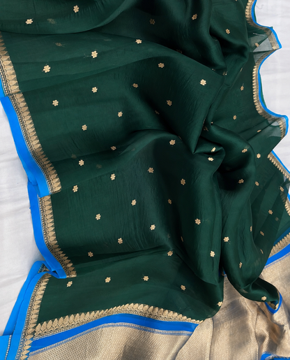 Dark green silk saree with small gold booti and blue zari border
