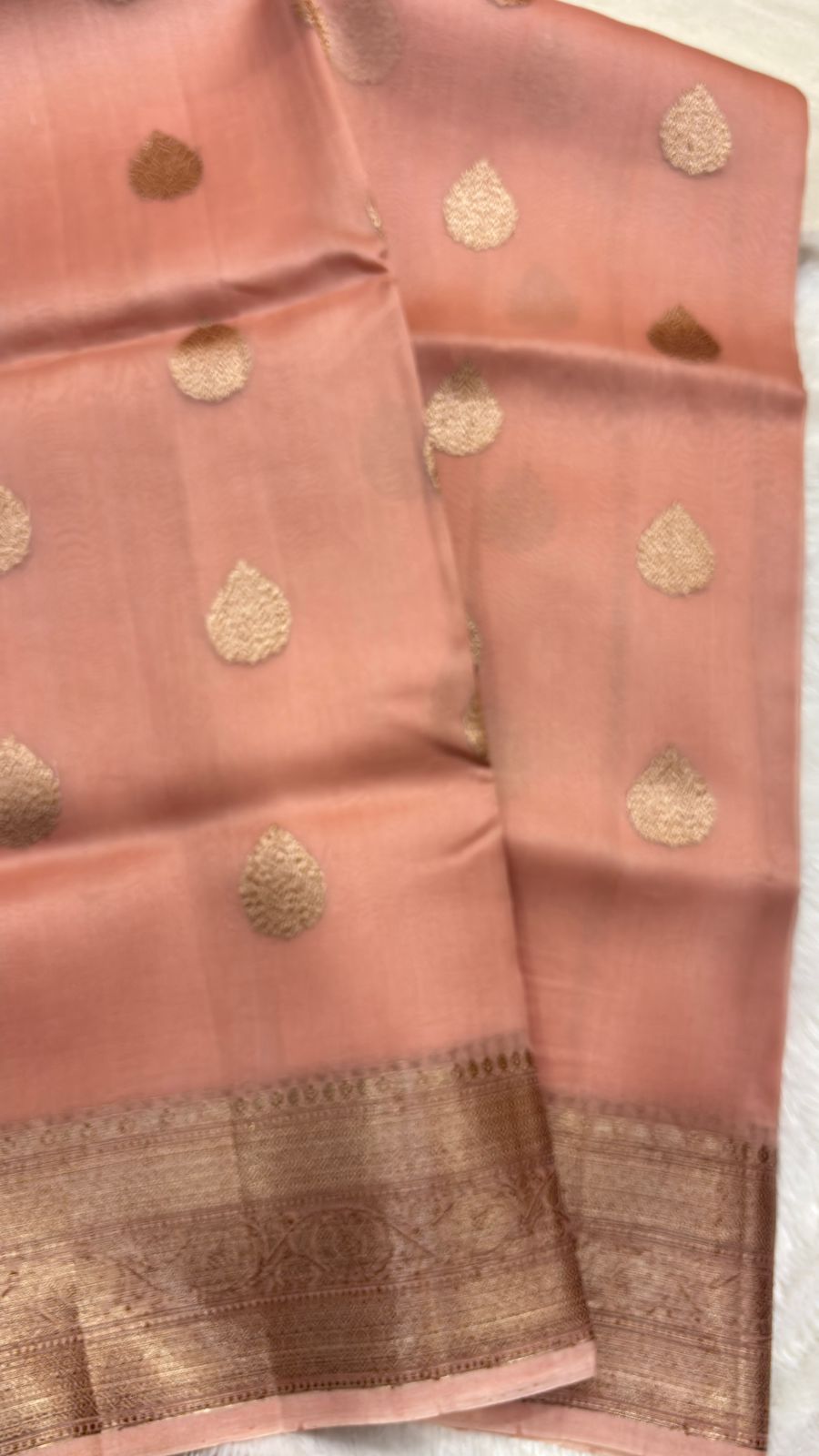 Peach pink saree with allover gold teardrop motifs and zari-edged border