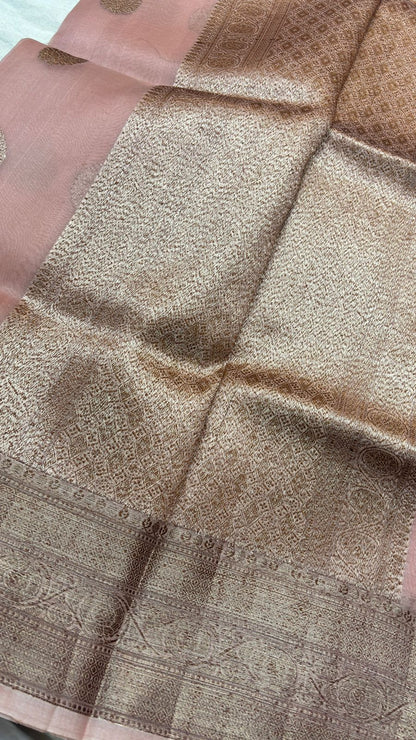 Peach pink saree close-up of textured body with ornate gold zari border
