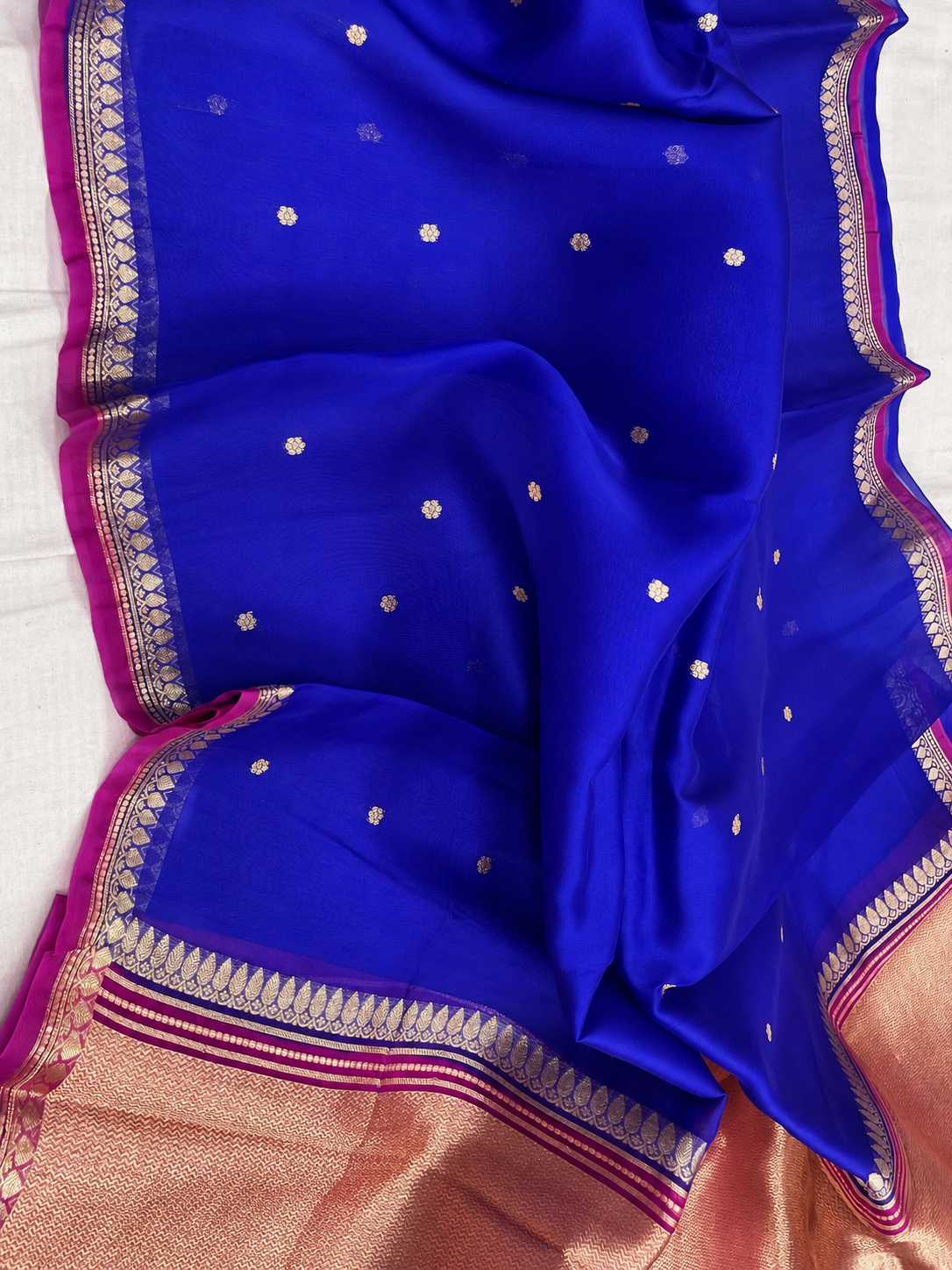 Blue silk saree with gold motifs and magenta-gold border