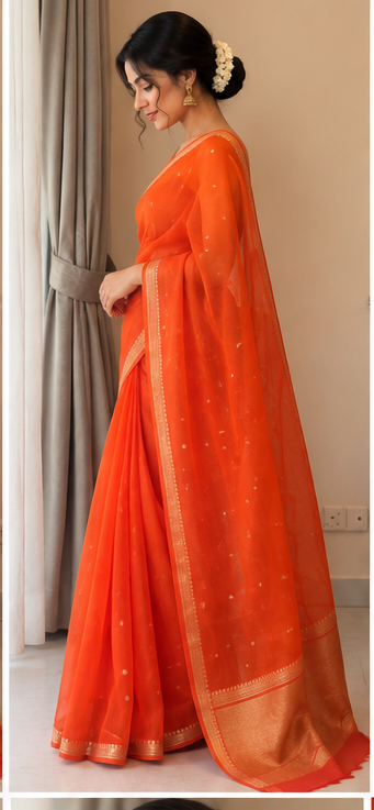 Orange silk saree with gold border and tiny dotted motifs, side view on model